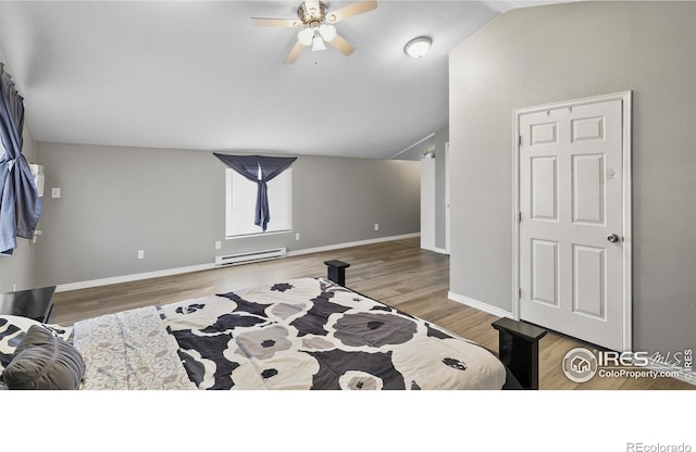 bedroom with ceiling fan, hardwood / wood-style floors, baseboard heating, and lofted ceiling