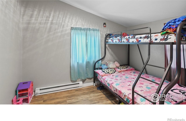 bedroom with a baseboard radiator and wood-type flooring