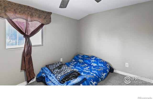 carpeted bedroom with ceiling fan and vaulted ceiling