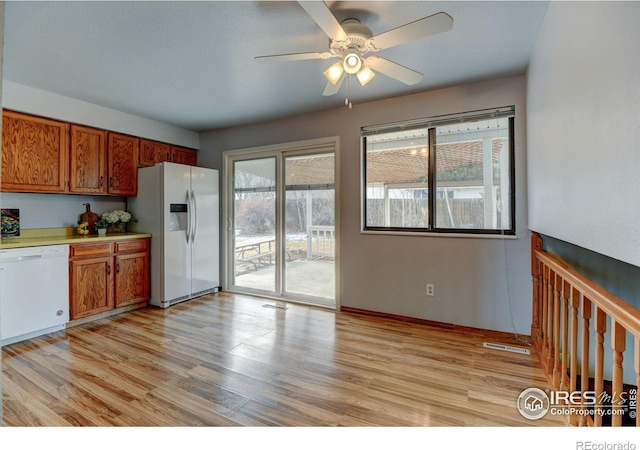 kitchen featuring white appliances, light wood-type flooring, and ceiling fan