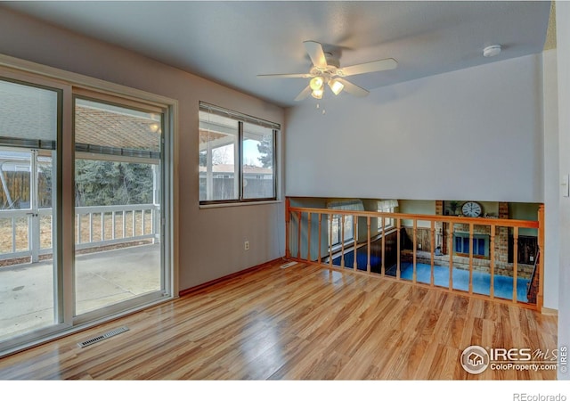 empty room with wood-type flooring and ceiling fan