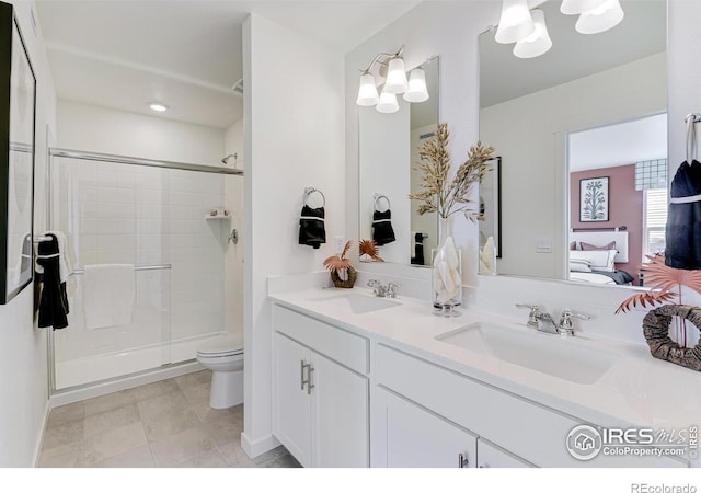 bathroom featuring tile patterned flooring, toilet, walk in shower, and vanity