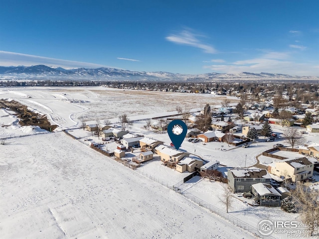 snowy aerial view with a mountain view