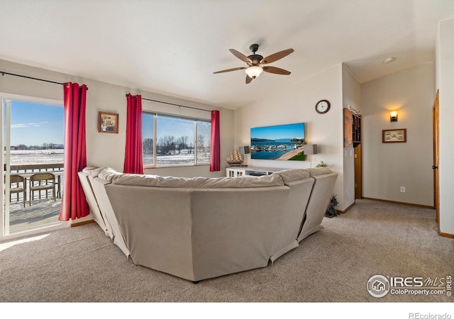 carpeted living room featuring ceiling fan, a healthy amount of sunlight, and lofted ceiling