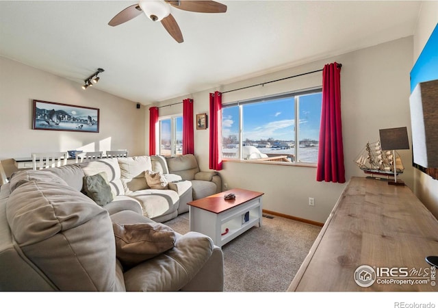 carpeted living room featuring ceiling fan and rail lighting