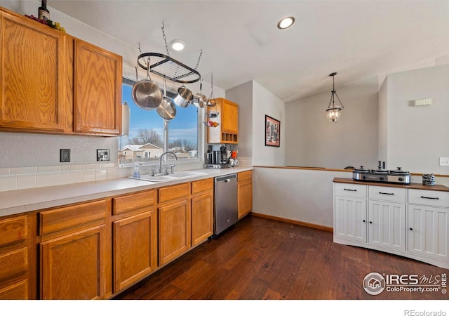 kitchen featuring sink, dark wood-type flooring, pendant lighting, and dishwasher