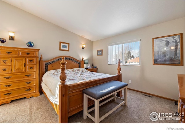 bedroom with carpet flooring and vaulted ceiling