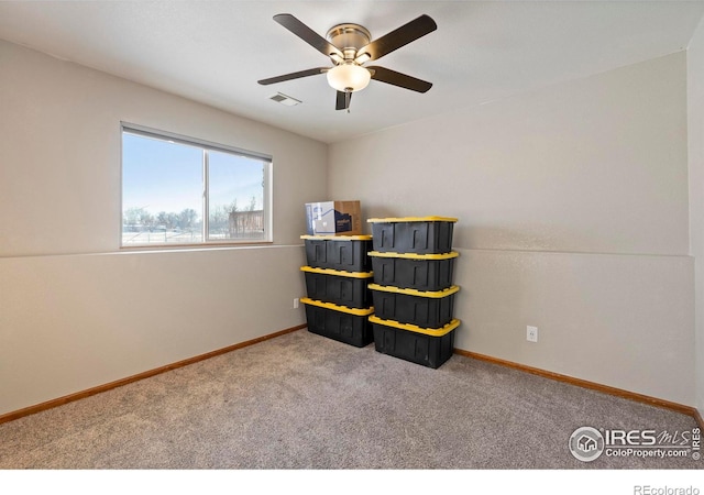 interior space featuring carpet floors and ceiling fan