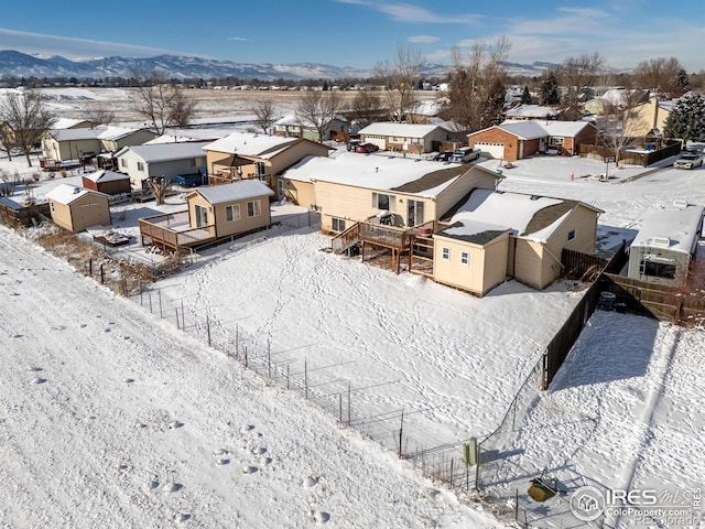 snowy aerial view with a mountain view