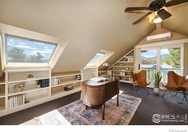 interior space featuring built in shelves, a wall mounted AC, ceiling fan, dark carpet, and lofted ceiling with skylight