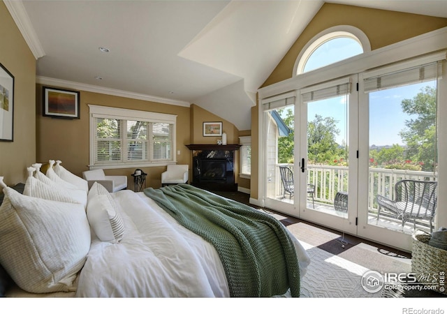 bedroom featuring a premium fireplace, access to exterior, lofted ceiling, and multiple windows