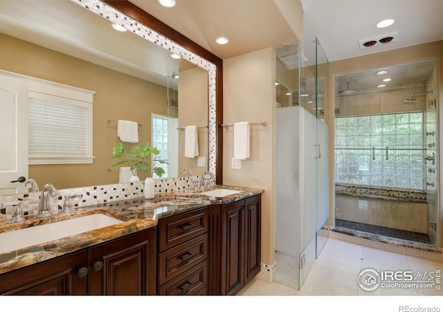 bathroom with tile patterned floors, an enclosed shower, and vanity