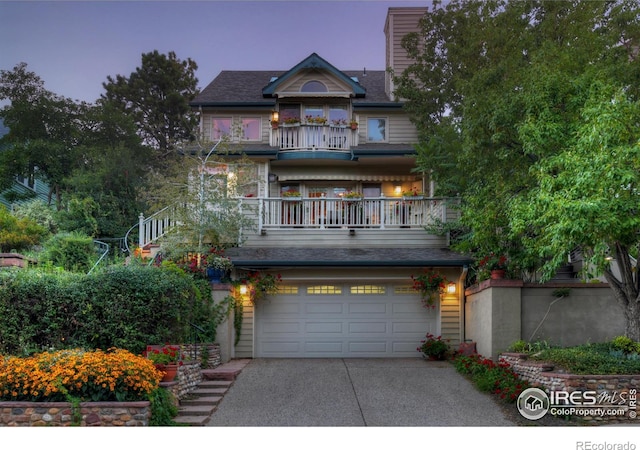 view of front of house featuring a balcony and a garage