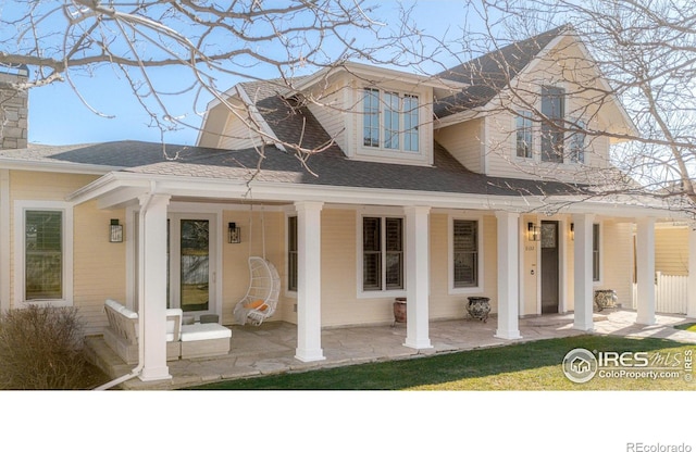 rear view of house featuring a porch