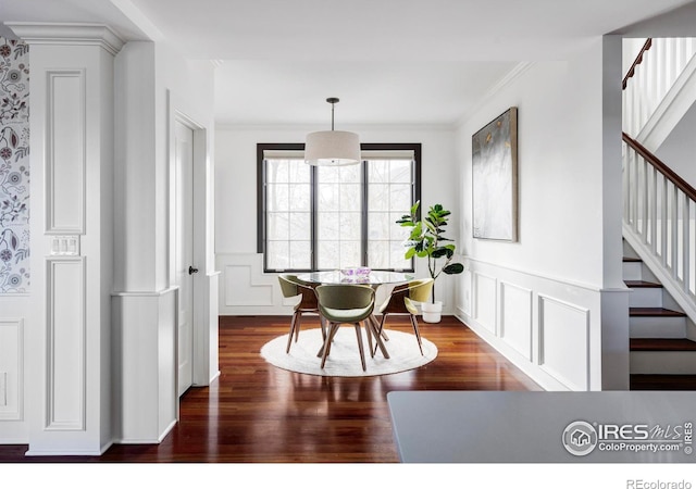 dining space featuring dark hardwood / wood-style floors and ornamental molding