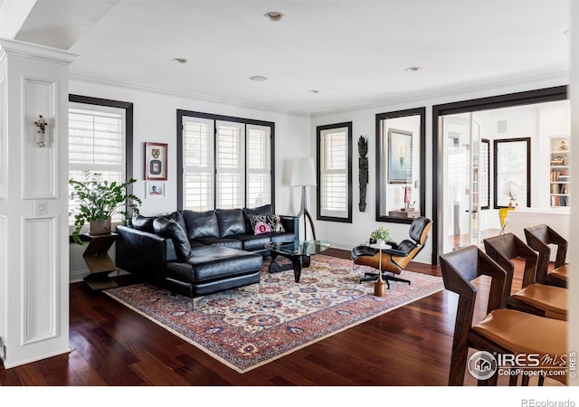 living room featuring ornamental molding and dark hardwood / wood-style flooring