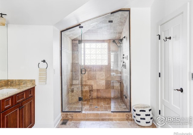 bathroom with vanity, a shower with shower door, and tile patterned floors