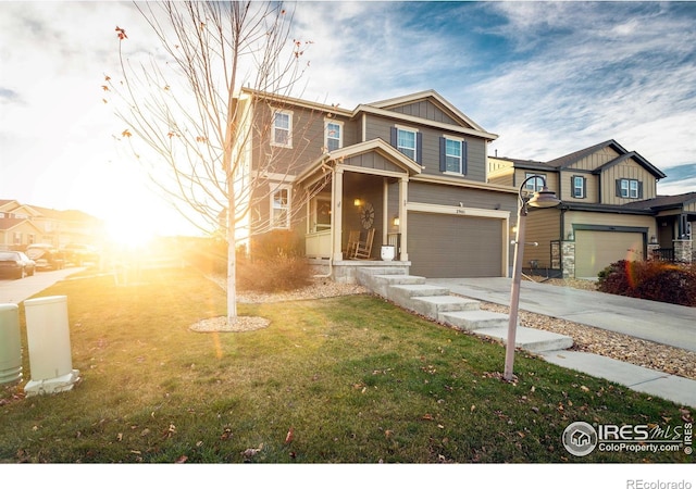 view of front of house with a garage and a yard