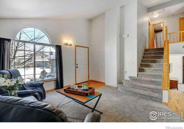 carpeted living room featuring stairway and baseboards