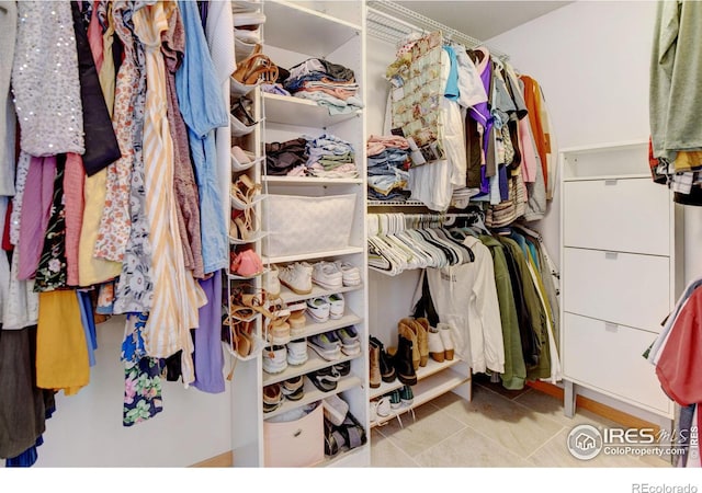 spacious closet with tile patterned floors