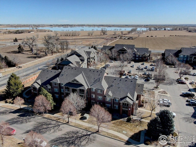 drone / aerial view featuring a water view and a residential view