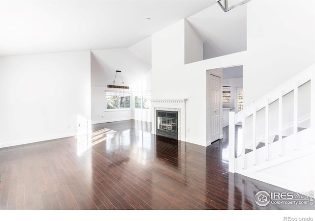 living room featuring high vaulted ceiling and dark hardwood / wood-style floors