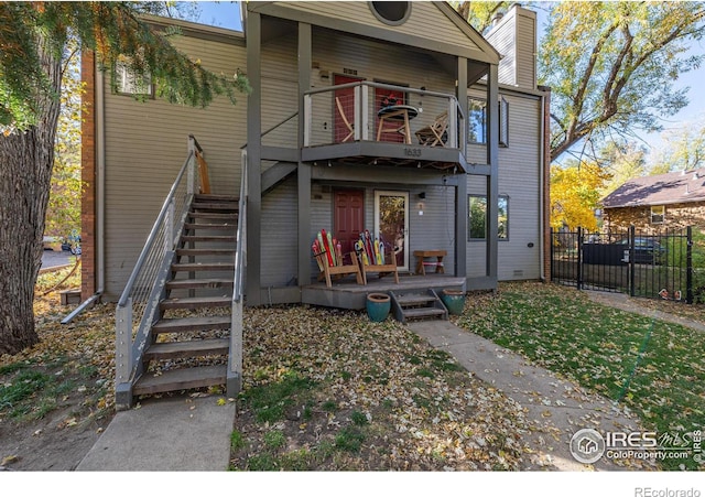 back of property with a balcony