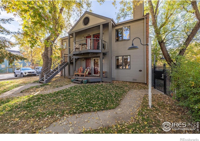 exterior space featuring stairs, fence, and a chimney