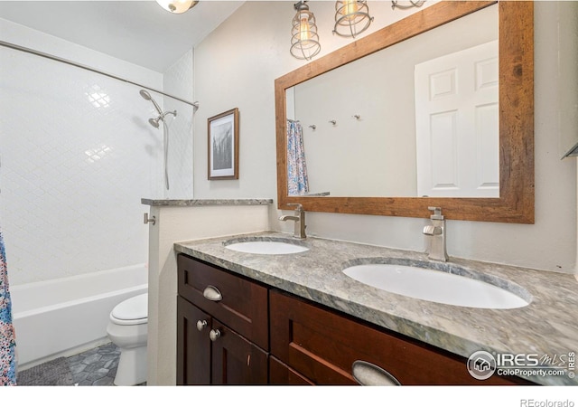 full bathroom featuring double vanity, toilet, shower / bath combo with shower curtain, and a sink