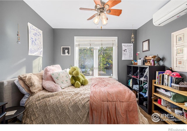 bedroom featuring a wall mounted air conditioner, ceiling fan, and access to outside