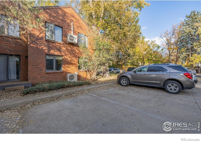 uncovered parking lot with an AC wall unit and ac unit