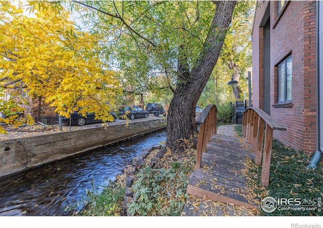 view of yard with a deck with water view