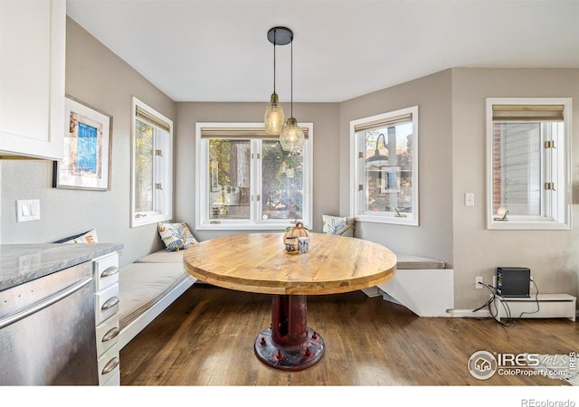 dining area featuring breakfast area and dark wood-type flooring