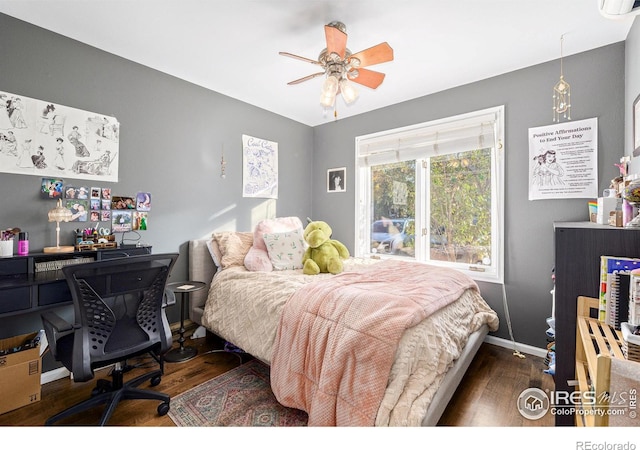 bedroom with ceiling fan, baseboards, and wood finished floors