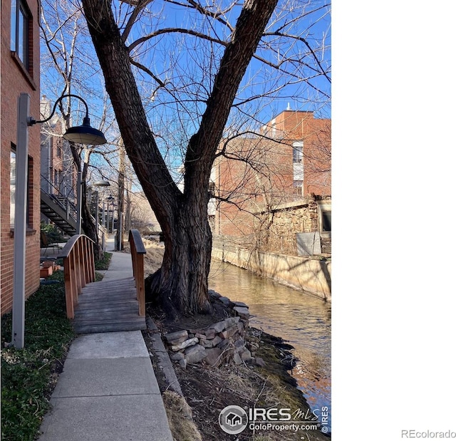 view of yard with stairway and a water view