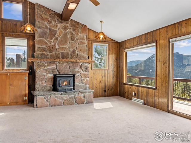 unfurnished living room with a mountain view, vaulted ceiling with beams, and plenty of natural light