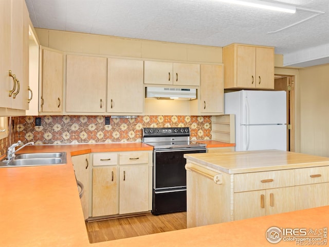 kitchen featuring sink, white refrigerator, light brown cabinetry, and range with electric stovetop