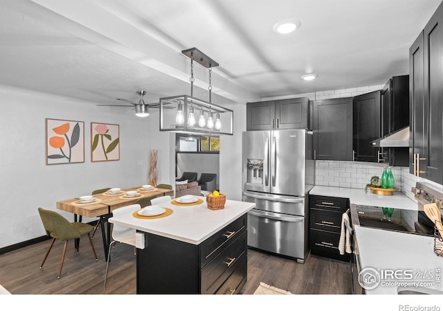 kitchen with dark wood-type flooring, hanging light fixtures, backsplash, stainless steel fridge with ice dispenser, and ceiling fan