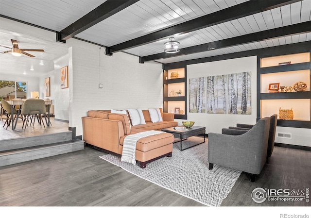 living room featuring built in shelves, ceiling fan, beam ceiling, and dark hardwood / wood-style floors