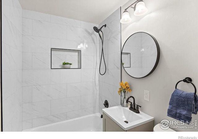 full bathroom featuring vanity, toilet, and tiled shower / bath