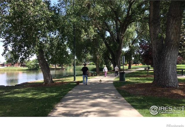 view of property's community featuring a water view and a lawn