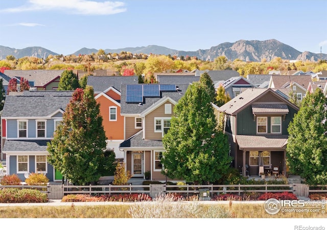 view of front of house with a mountain view and solar panels