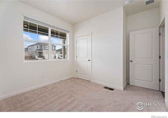 unfurnished bedroom with light carpet