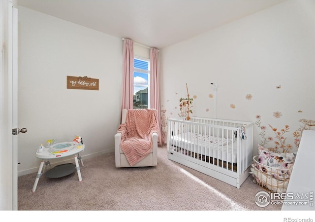 carpeted bedroom with a crib