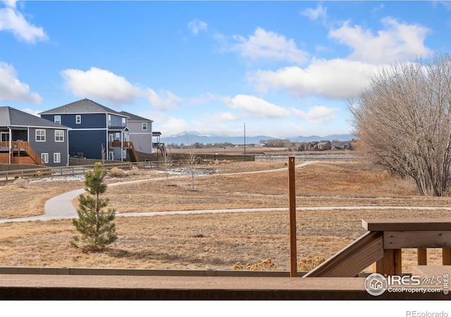 view of yard with a mountain view and a rural view