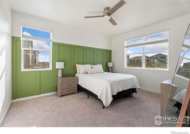 bedroom featuring ceiling fan and light carpet