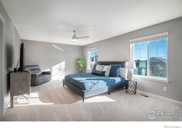 bedroom with ceiling fan and light colored carpet