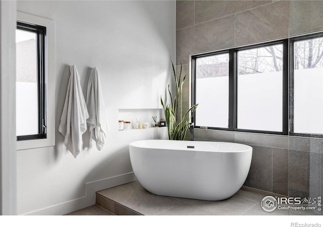 bathroom featuring tile patterned flooring and a tub