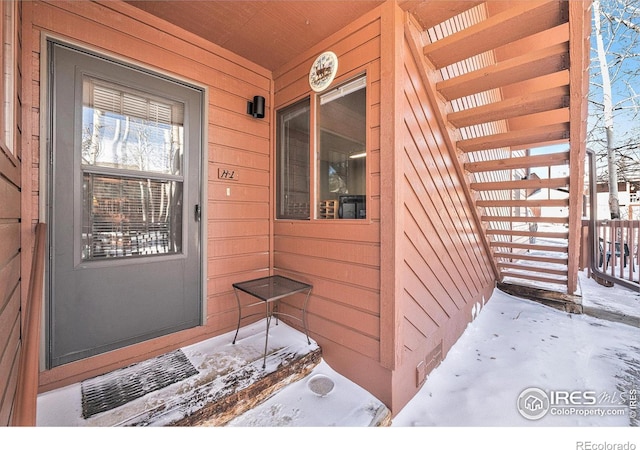 view of snow covered property entrance