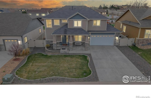 view of front of home featuring a garage and a lawn